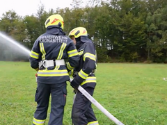 Members of the volunteer fire brigade with a fire hose during an exercise