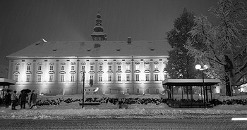 Landhaus in Klagenfurt beleuchtet bei Dunkelheit und Schnee. 